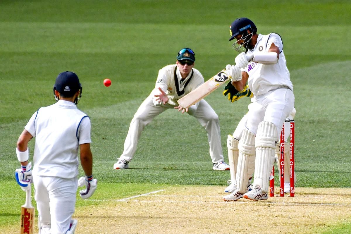 Cheteshwar Pujara plays a shot for four runs during the day one of the first cricket Test match between Australia and India in Adelaide. Credit: AFP