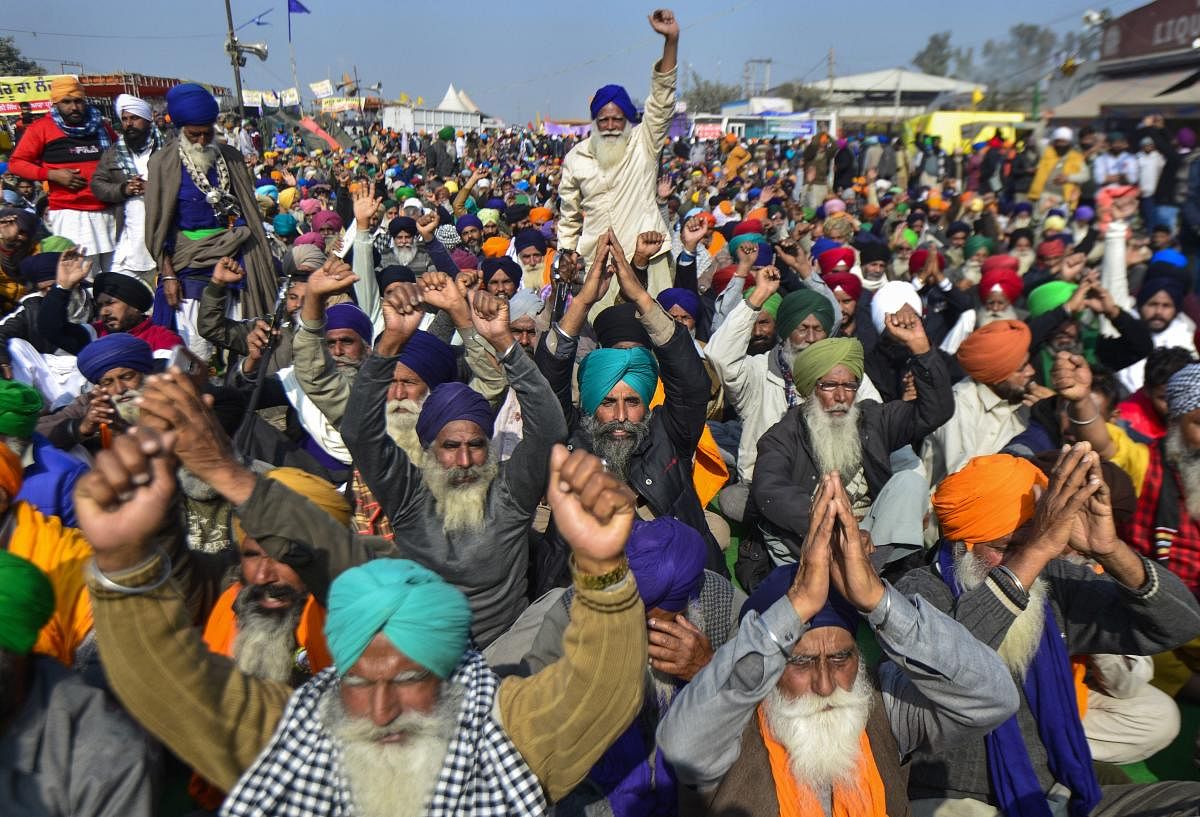 Farmers shout slogans during their protest against the new farm laws, at Singhu Border in New Delhi, Wednesday, Dec. 16, 2020. Credit: PTI Photo