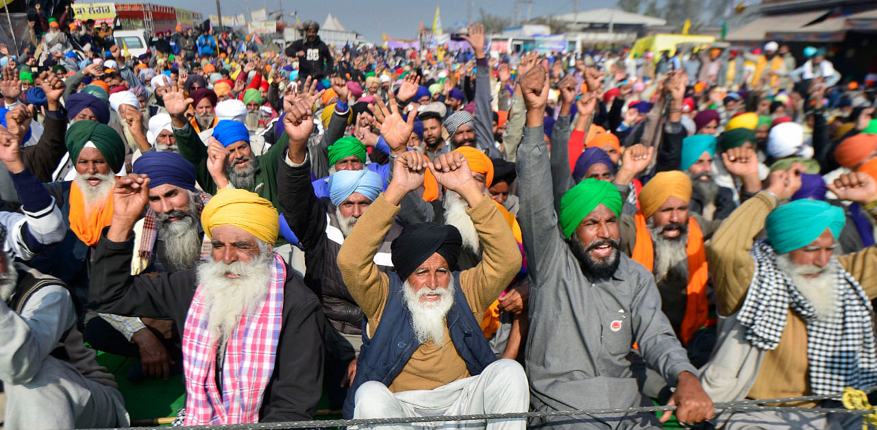 Farmers shout slogans during their protest against the new farm laws, at Singhu Border in New Delhi. Credit: PTI Photo