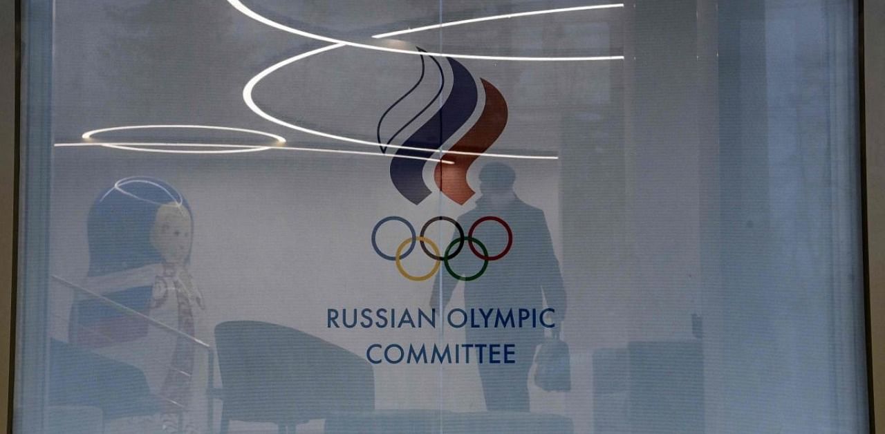 A picture shows the logo of the Russian Olympic Committee (ROC) on the window of its headquarters in Moscow. Credit: AFP.