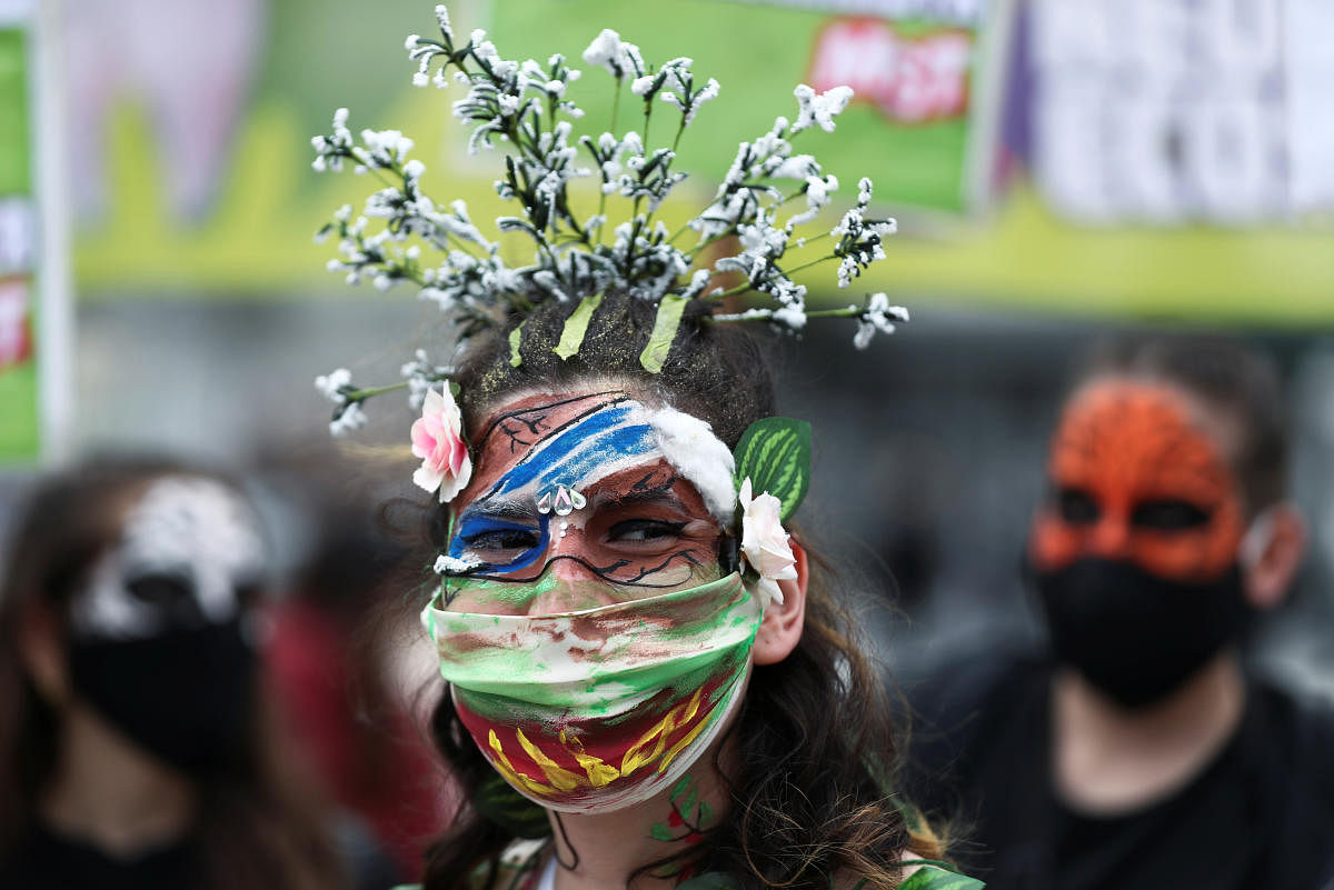 A demonstrator with body painting depicting Mother Nature smiles as Fridays for Future activists protest calling for a "Global Day of Climate Action", in Buenos Aires, Argentina September 25, 2020. Credit: REUTERS
