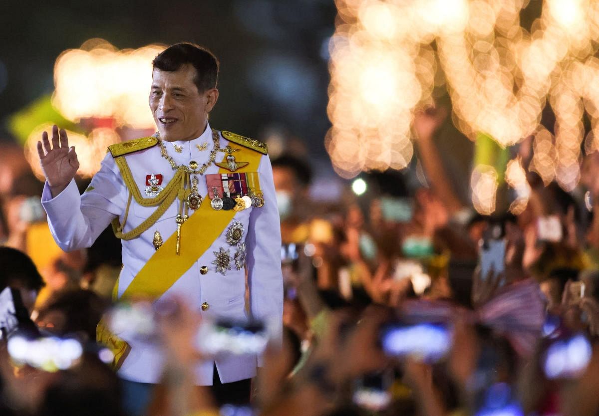 Thailand's King Maha Vajiralongkorn greets royalists at a candlelight vigil to remember the birthday of Thailand's late King Bhumibol Adulyadej, outside the Grand Palace in Bangkok, Thailand, December 5, 2020. Credit: REUTERS