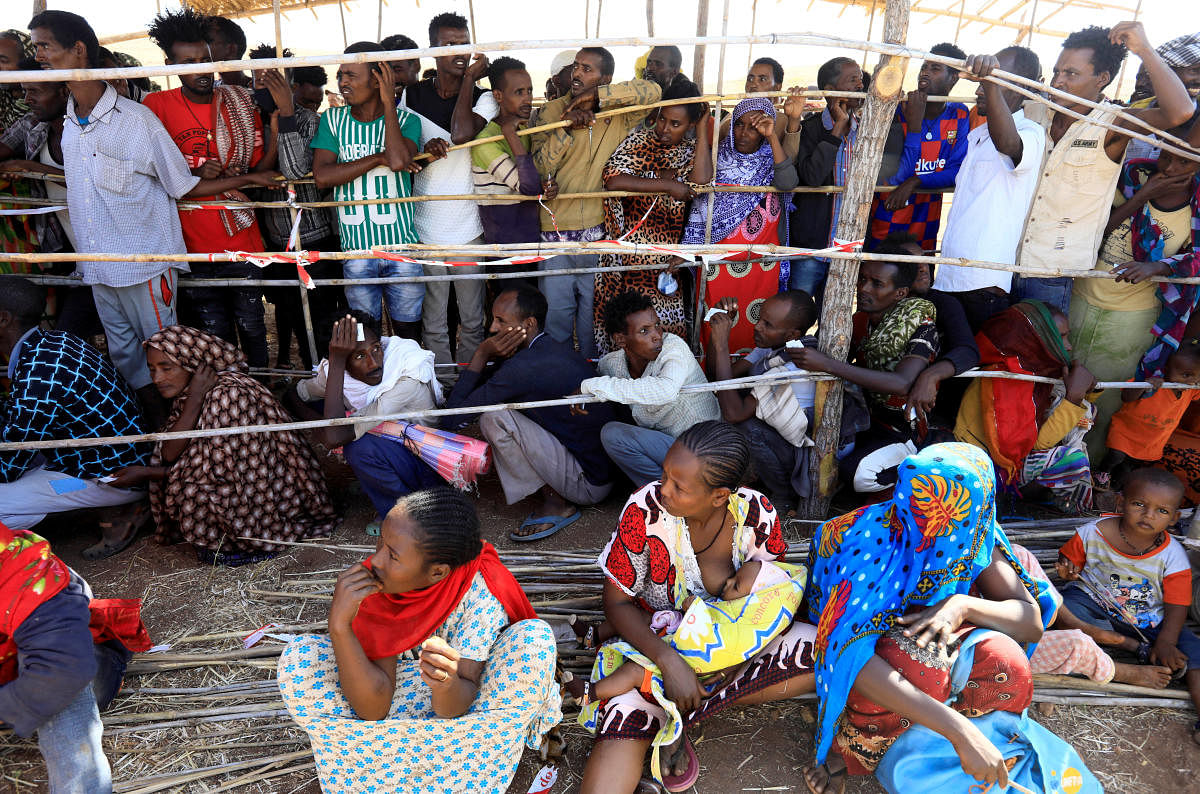 Ethiopians who fled the ongoing fighting in Tigray region gather to receive relief aid at the Um-Rakoba camp on the Sudan-Ethiopia border, in Kassala state, Sudan December 17. Credit: Reuters Photo