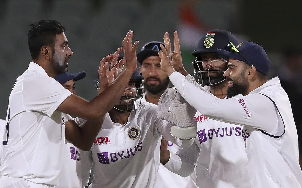 India's Ravichandran Ashwin, left, celebrates with teammates after taking the wicket of Australia's Nathan Lyon on the second day of their cricket test match at the Adelaide Oval in Adelaide, Australia, Friday, Dec. 18, 2020. Credit: AP/PTI
