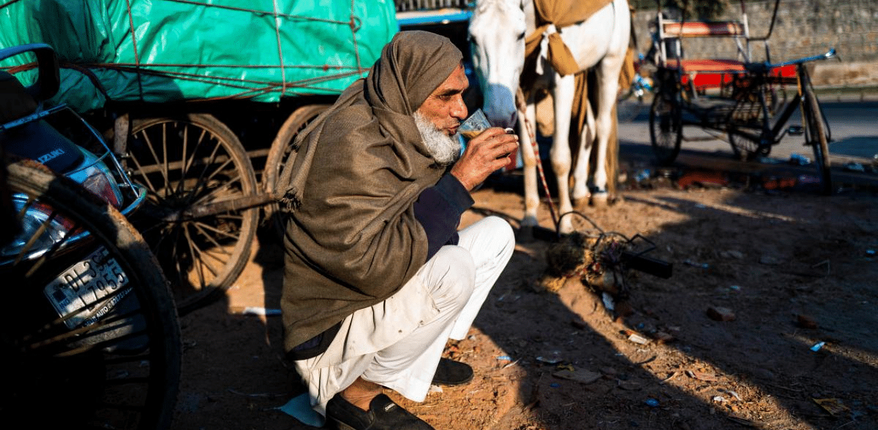 A man sips a cup of tea during a cold winter morning in the old quarters of New Delhi. Credit: AFP