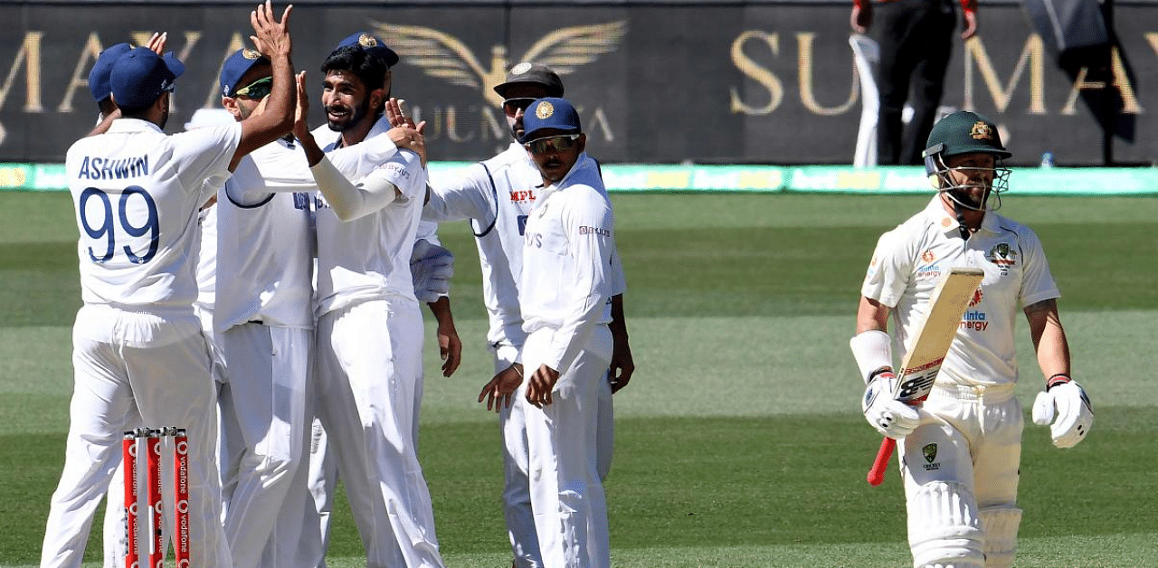 India's paceman Jasprit Bumrah (2nd L) celebrates his wicket of Australia's batsman Matthew Wade (R) on day two of the first cricket Test match between Australia and India in Adelaide. Credit: AFP Photo