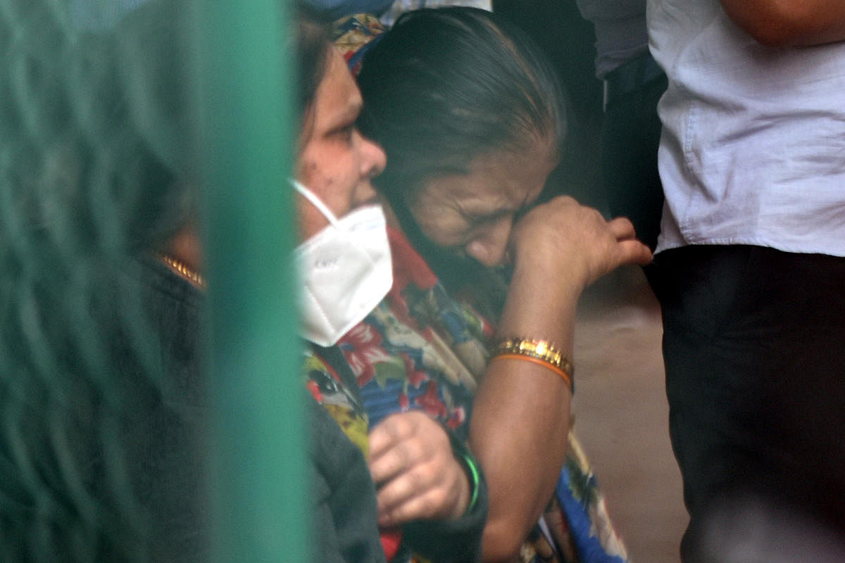 A relative grieves the officer's death in Bengaluru on Thursday. Credit: DH PHOTO/S K DINESH