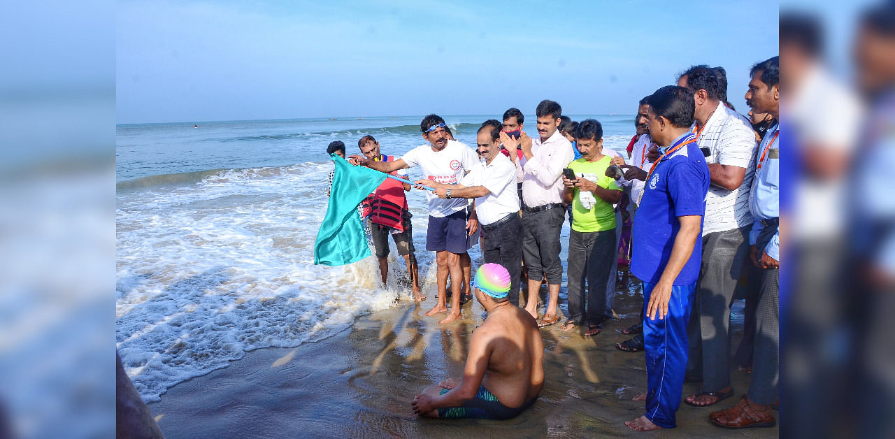 The swimming feat is being flagged off at Thannirbavi beach. Credit: DH Photo