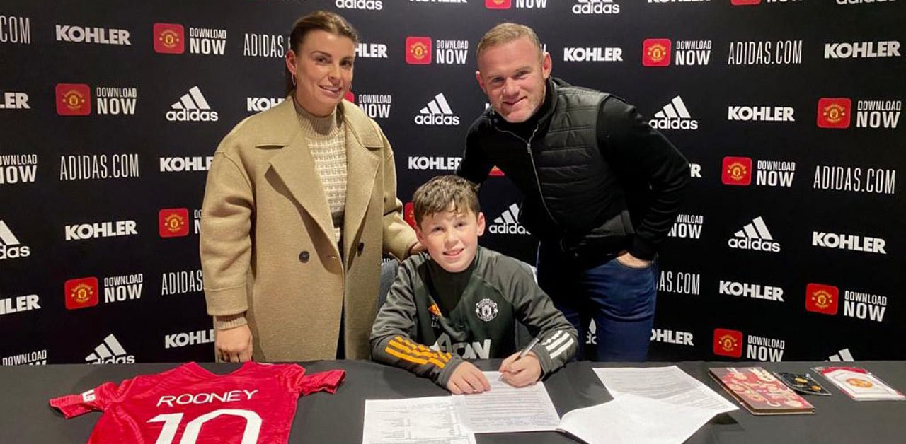 Wayne Rooney with son Kai at the signing. Credit: Twitter Photo/WayneRooney
