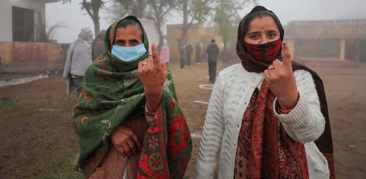 Voters show their fingers marked with indelible ink after casting their votes for the last phase of District Development Council (DDC) election, at Khour village in Akhnoor, Jammu. Credit: PTI