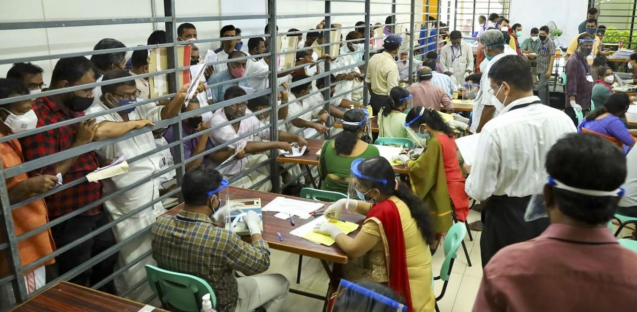 Officials count votes during counting day of Kerala local body elections, in Kozhikode. Credit: PTI.