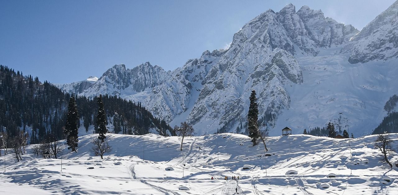People walk on snow covered slopes of Sonamarg in Ganderbal district of Central Kashmir. Credit: PTI Photo