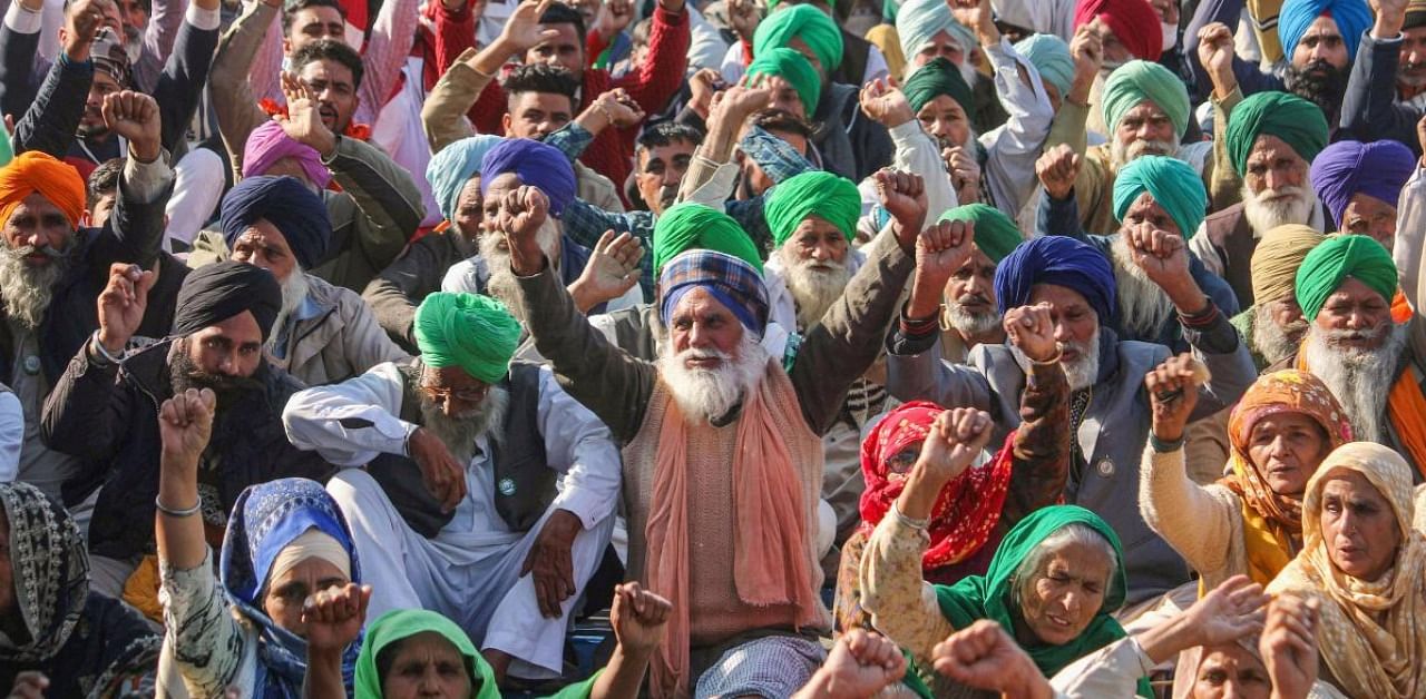 Farmers gather at Tikri border during their sit-in protest against the Centre's farm reform laws, in New Delhi. Credit: PTI.