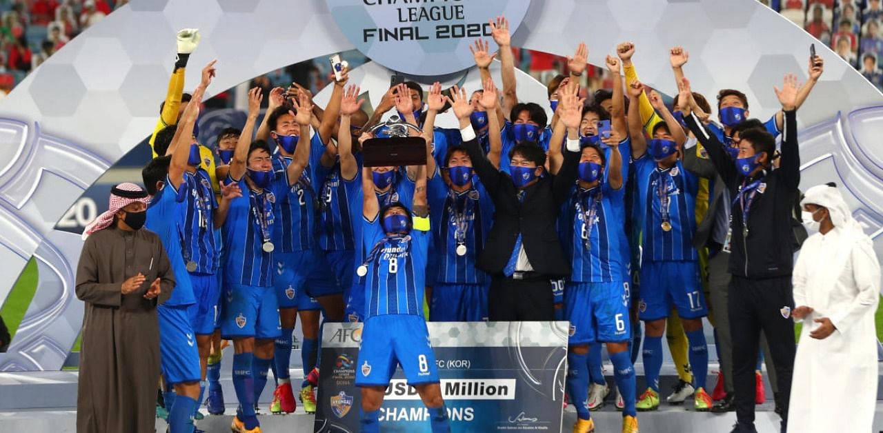 Ulsan Hyundai FC's Sin Jin-Ho lifts the trophy as they celebrate winning the AFC Champions League. Credit: Reuters.