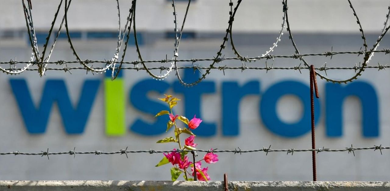 The logo of Wistron, a Taiwanese-run iPhone factory, is seen at Narsapura, about 60 km from Bangalore on December 13, 2020. Credit: AFP Photo