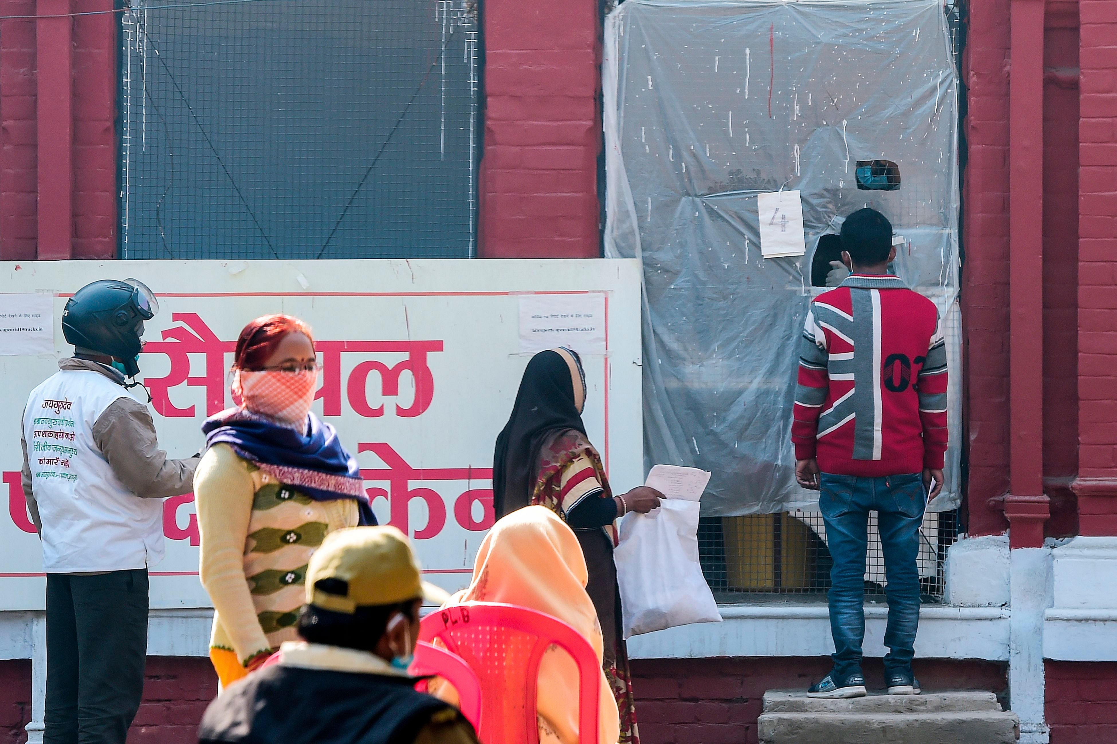 A health official takes a swab sample from a man to test for the Covid-19 coronavirus at a testing centre in Allahabad. Credit: AFP Photo