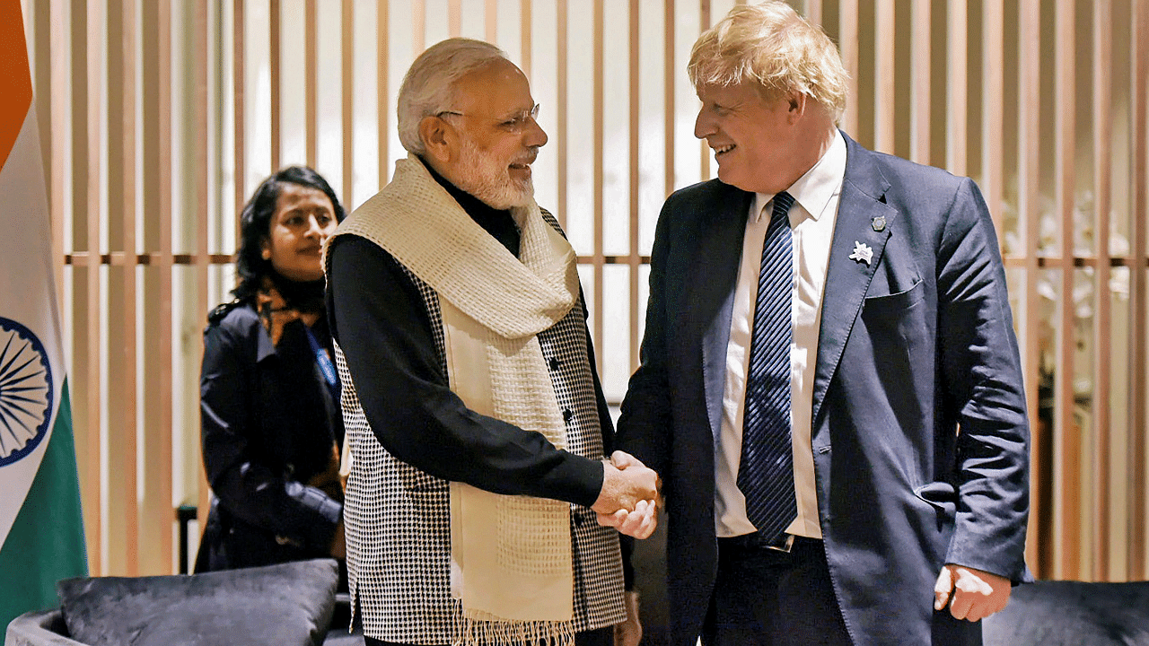 Prime Minister Narendra Modi shakes hands with United Kingdom Prime Minister Boris Johnson. Credit: PTI Photo
