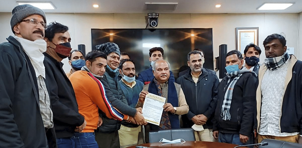  Union Minister Narendra Singh Tomar with farmers from UP during a meeting on farm reform laws, in New Delhi. Credit: PTI Photo