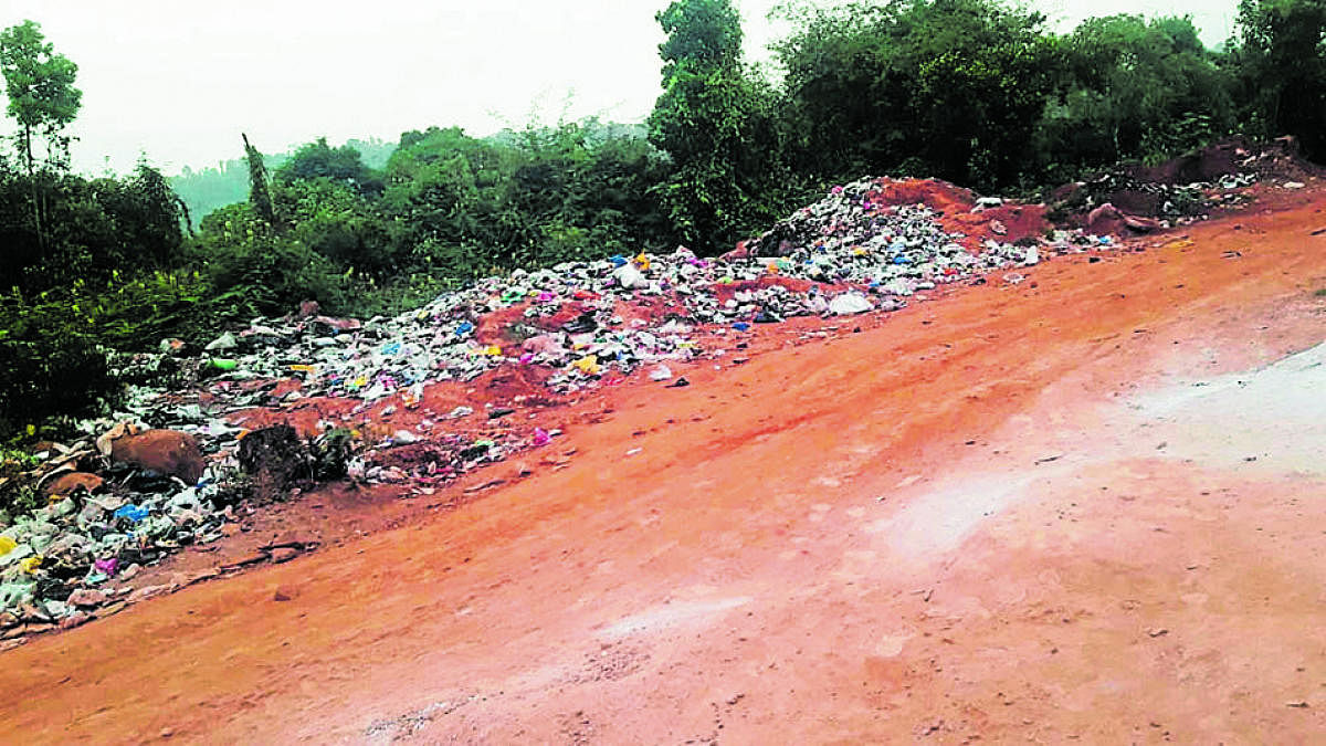 Garbage dumped at the layout where rain victims are rehabilitated at Jambooru Bane.