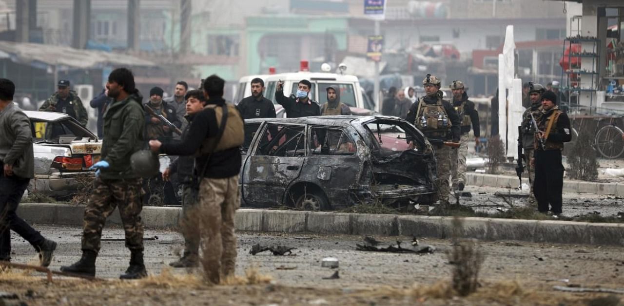 Kabul:Afghan security personnel inspect the site of a bombing attack in Kabul, Afghanistan. Credit: AP/PTI.