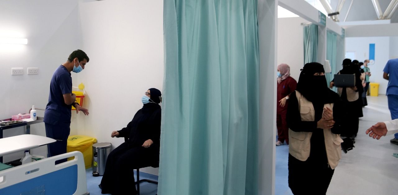 A Saudi woman waits to get a dose of a coronavirus vaccine, in Riyadh, Saudi Arabia. Credit: Reuters Photo