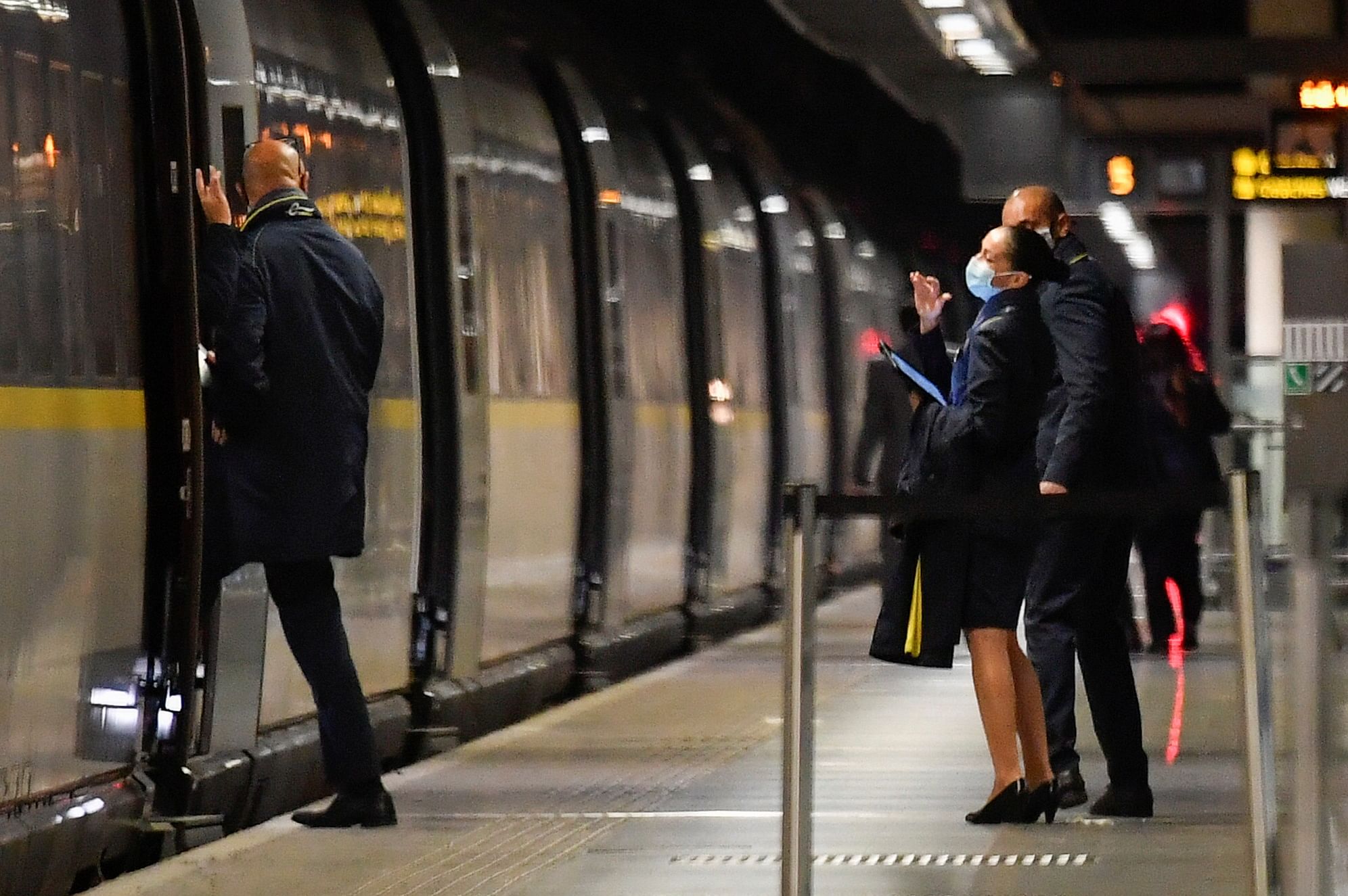 Train personnel wave to each other as one of them boards the last scheduled Eurostar train from London to Paris. Credit: Reuters Photo