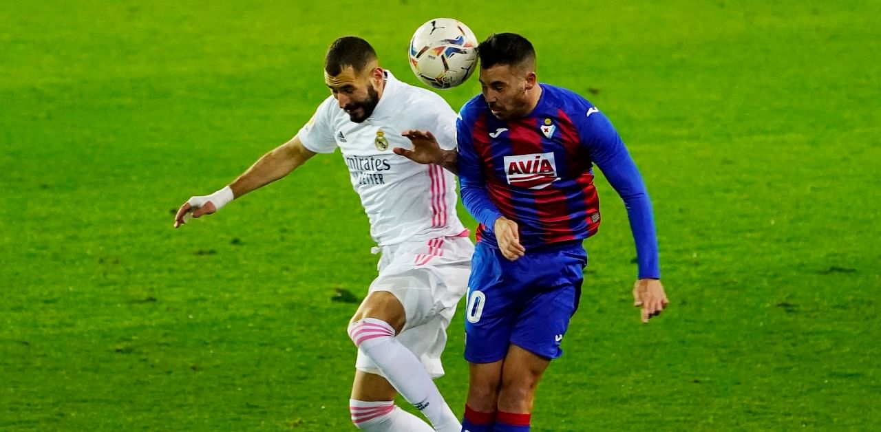 Real Madrid's Karim Benzema in action with Eibar's Edu Exposito. Credit: Reuters Photo