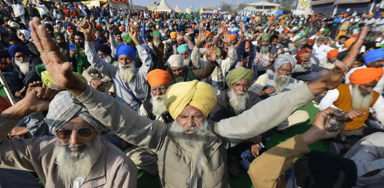 Farmers raise slogans during their protest against the farm laws at Singhu Border, in New Delhi. Credit: PTI Photo
