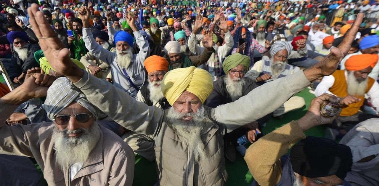 Farmers raise slogans during their protest against the farm laws at Singhu Border, in New Delhi. Credit: PTI.