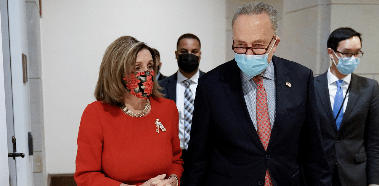 Speaker of the House Nancy Pelosi and Senate Minority Leader Charles Schumer walk following a press conference on an agreement of a Covid-19 aid package on Capitol Hill in Washington, DC. Credit: Reuters