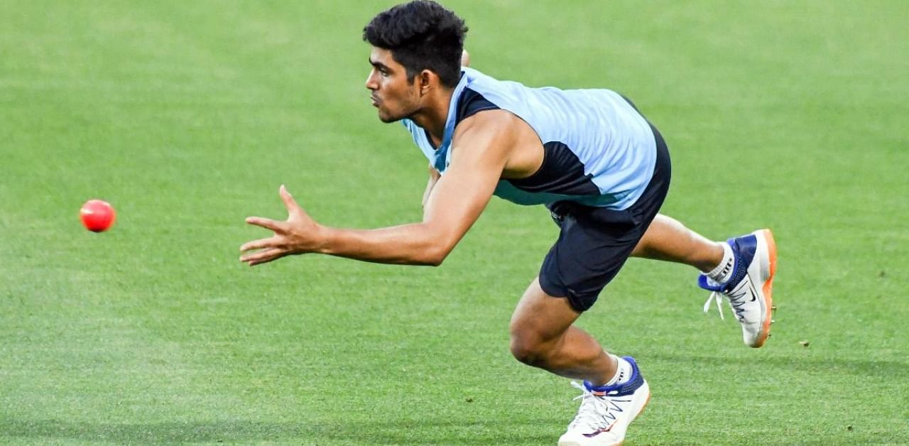India's Shubman Gill dives to catch the ball during a practice session in Adelaide. Credit: AFP.