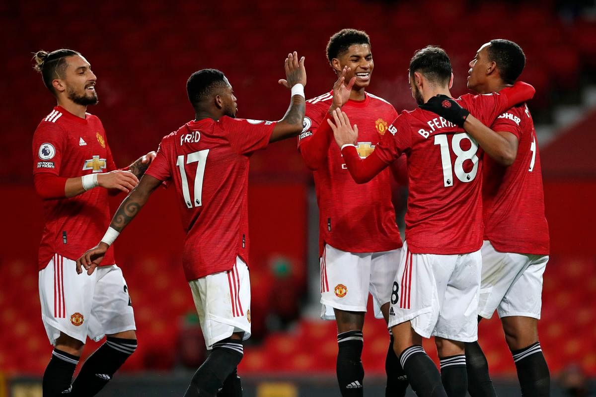 Manchester United's Portuguese midfielder Bruno Fernandes (2nd R) celebrates with teammates after scoring their sixth goal from the penalty spot during the English Premier League football match between Manchester United and Leeds United at Old Trafford in Manchester, north west England. Credit: AFP