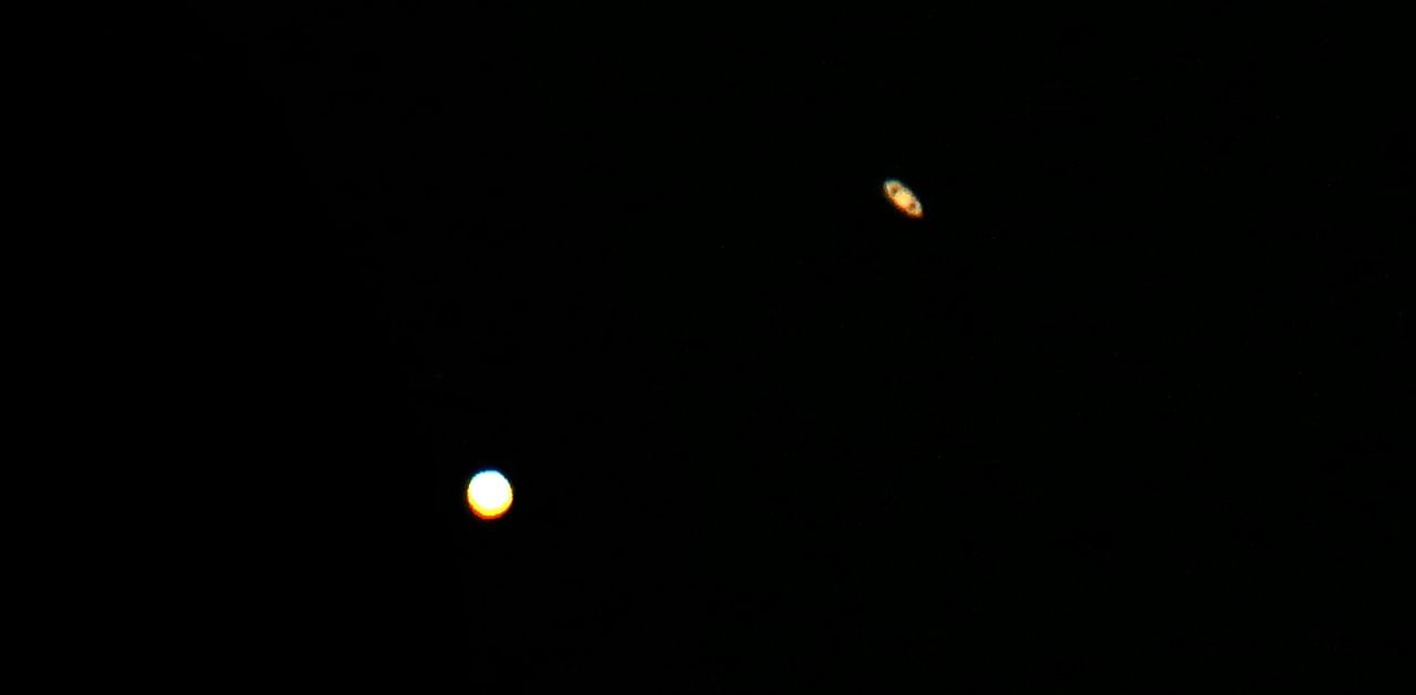 A picture taken on December 21, 2020, in al-Salmi district, a desert area 120 kms west of Kuwait City, shows the great conjunction of Jupiter and Saturn. Credit: AFP Photo