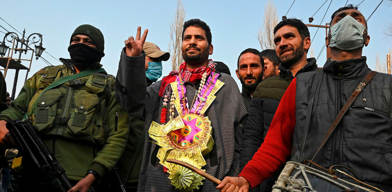 Aijaz Hussain (C), the Bharatiya Janata Party candidate for the District Development Council (DDC) polls celebrates after he won a DDC seat outside a counting centre in Srinagar. Credit: AFP Photo
