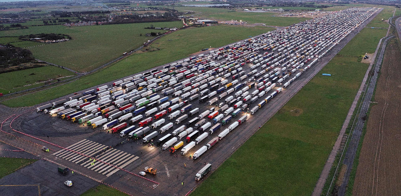 An aerial view shows lines of freight lorries and heavy goods vehicles parked on the tarmac at Manston Airport near Ramsgate, south east England. Credit: AFP Photo