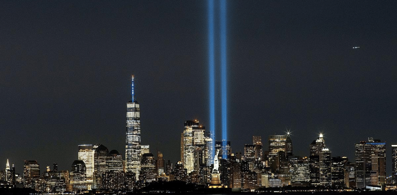 The Statue of Liberty and One World Trade Center are seen as the Tribute in Light shines in downtown Manhattan. Credit: Reuters Photo 