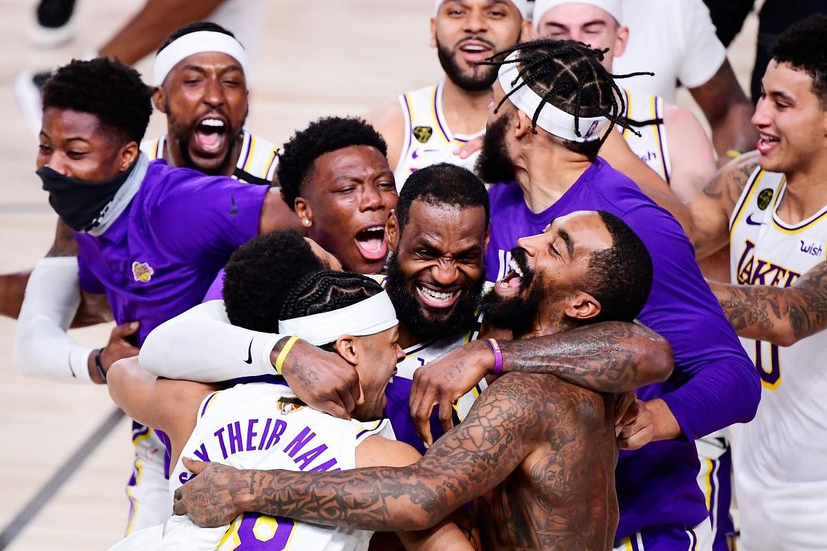 (FILES) In this file photo taken on October 11, 2020, LeBron James (C) of the Los Angeles Lakers celebrates with teammates after winning the 2020 NBA Championship in Game Six at AdventHealth Arena in Lake Buena Vista, Florida. NOTE TO USER: User expressly