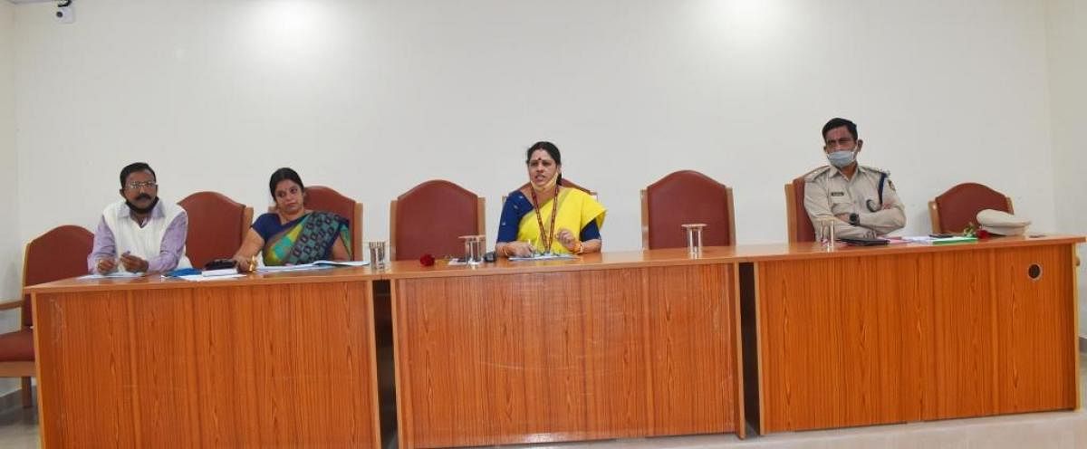 Shyamala S Kunder, a member of National Commission for Women, chairs a progress review meeting of the women and child welfare programmes in Madikeri on Monday.