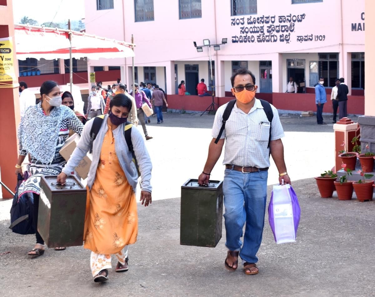 Polling officials leave for their respective polling booths in Madikeri.