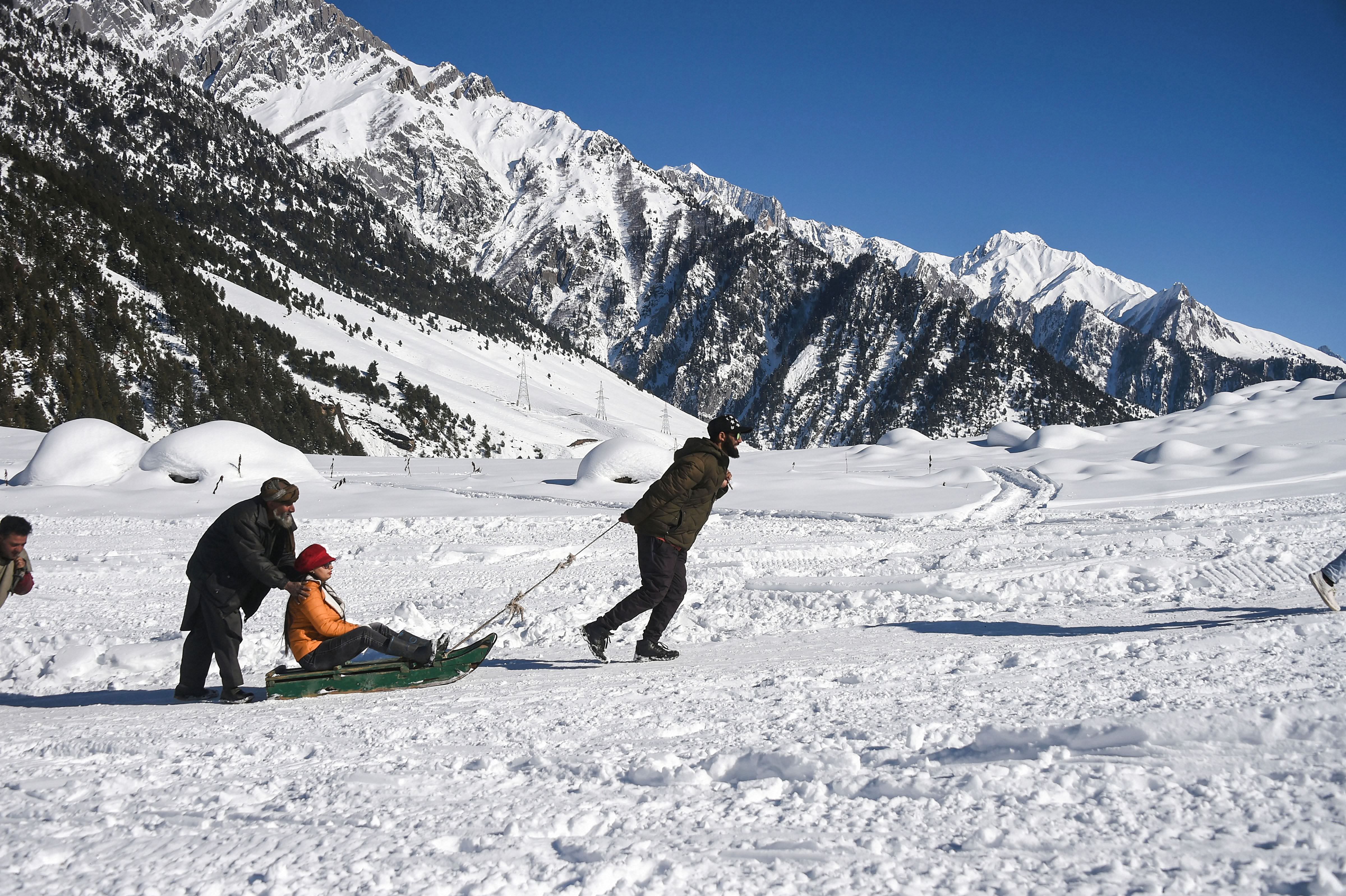 A tourist rides a sledge on a snow-covered meadow after recent snowfall at Sonamarg in Ganderbal district of Central Kashmir. Credit: PTI Photo
