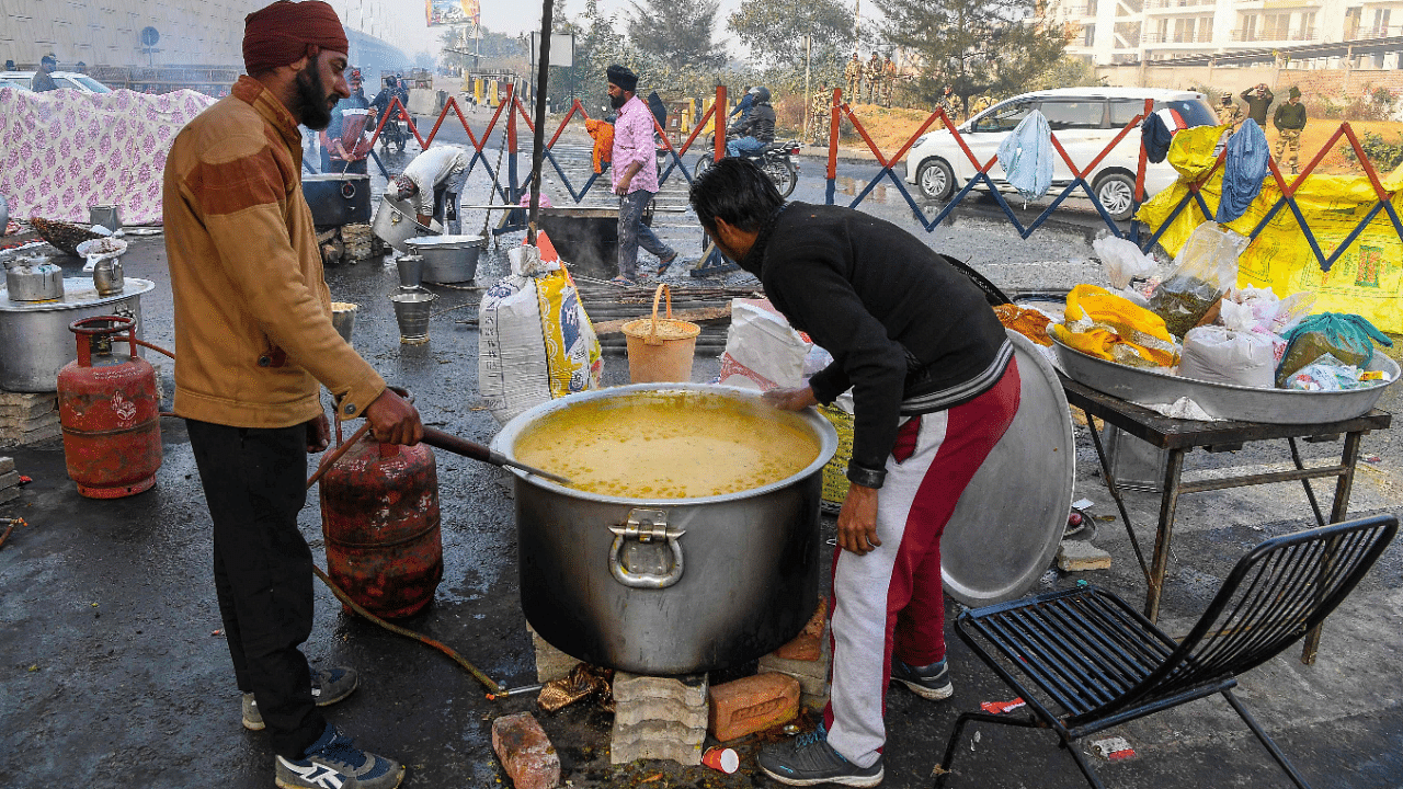 Volunteers prepare breakfast for farmers next to a blocked highway during a protest against the central government's recent agricultural reforms in Ghazipur. Credit: AFP Photo