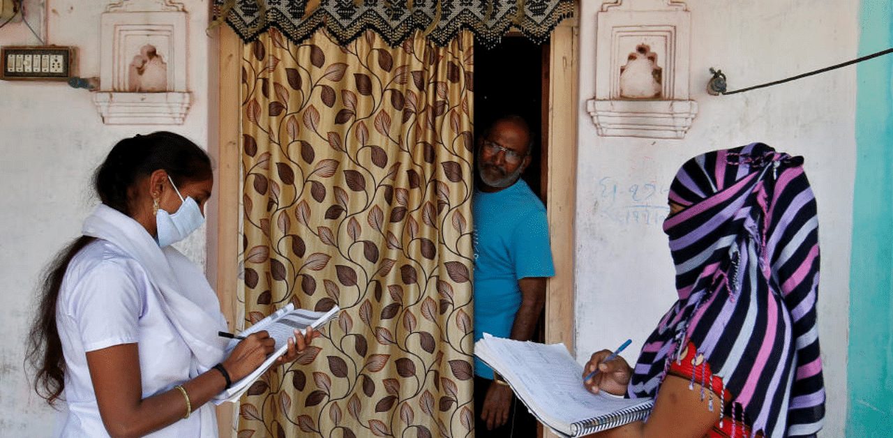 Health workers collect personal data during a door-to-door survey for the first shot of COVID-19 vaccine for people above 50 years of age and those with comorbidities, in a village on the outskirts of Ahmedabad, India, December 14, 2020. Credit: Reuters File Photo