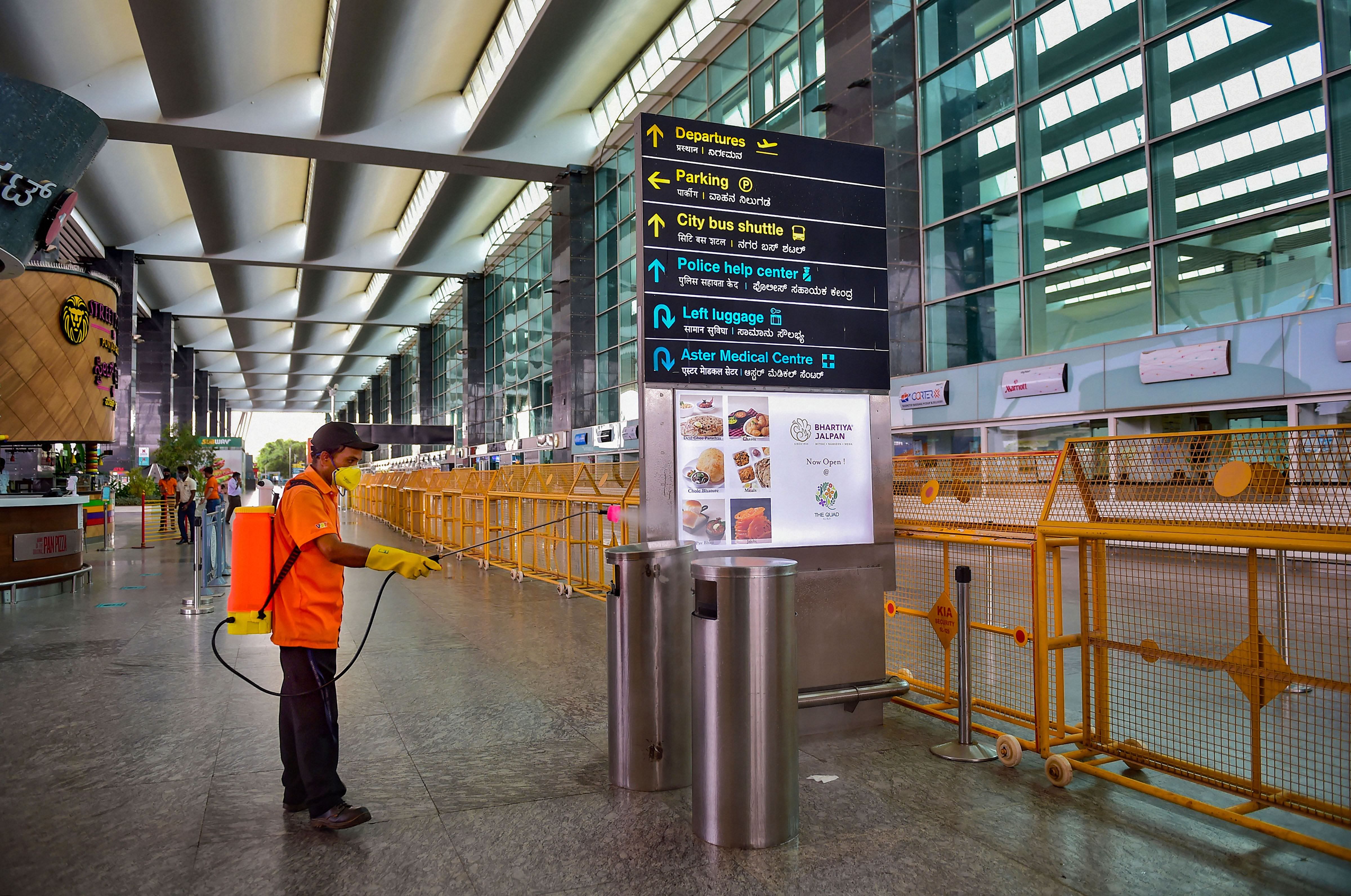 A worker sprays disinfectant at the Kempegowda International Airport. Credit: PTI Photo