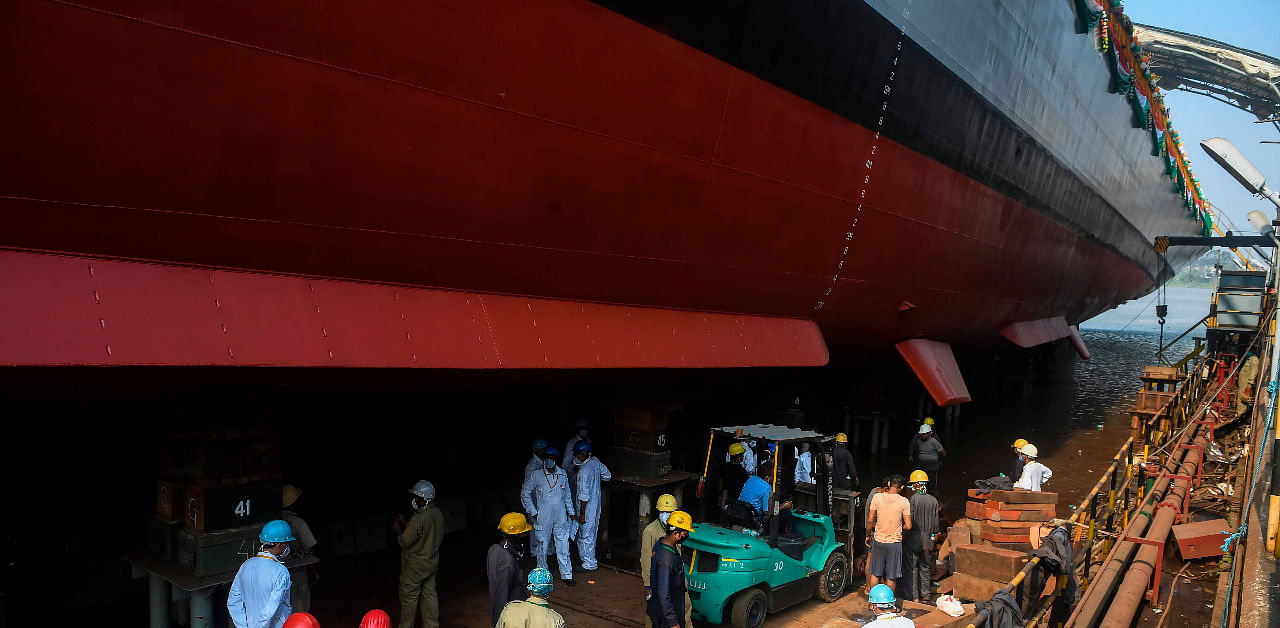 Shipyard workers carry on works on the hull of the stealth frigate Himgiri before the launch ceremony into the Hooghly River in Kolkata. Credit: AFP Photo