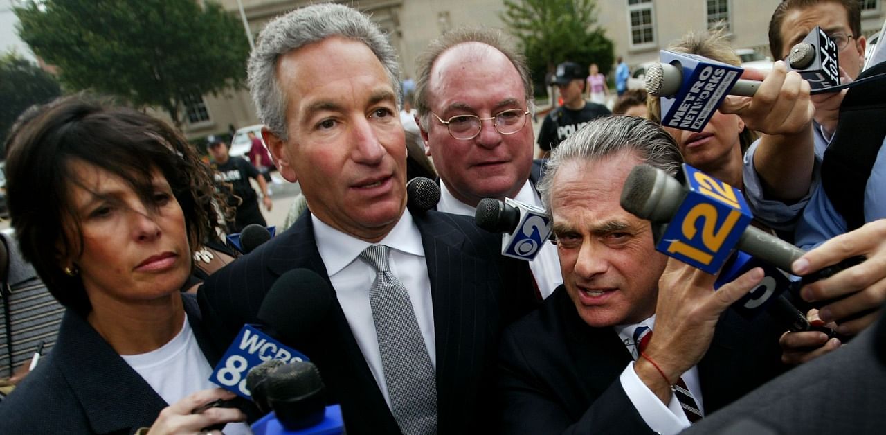 In this file photo Charles Kushner (C) wades though the media with his wife and legal team to the US District Courthouse on August 18, 2004 in Newark. Credit: AFP Photo