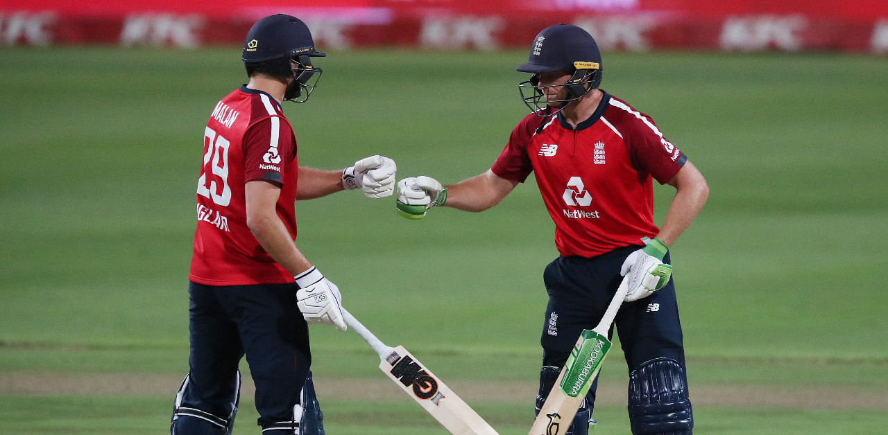 England's Dawid Malan and Jos Buttler celebrate in a T20 match against South Africa. Credit: Reuters Photo