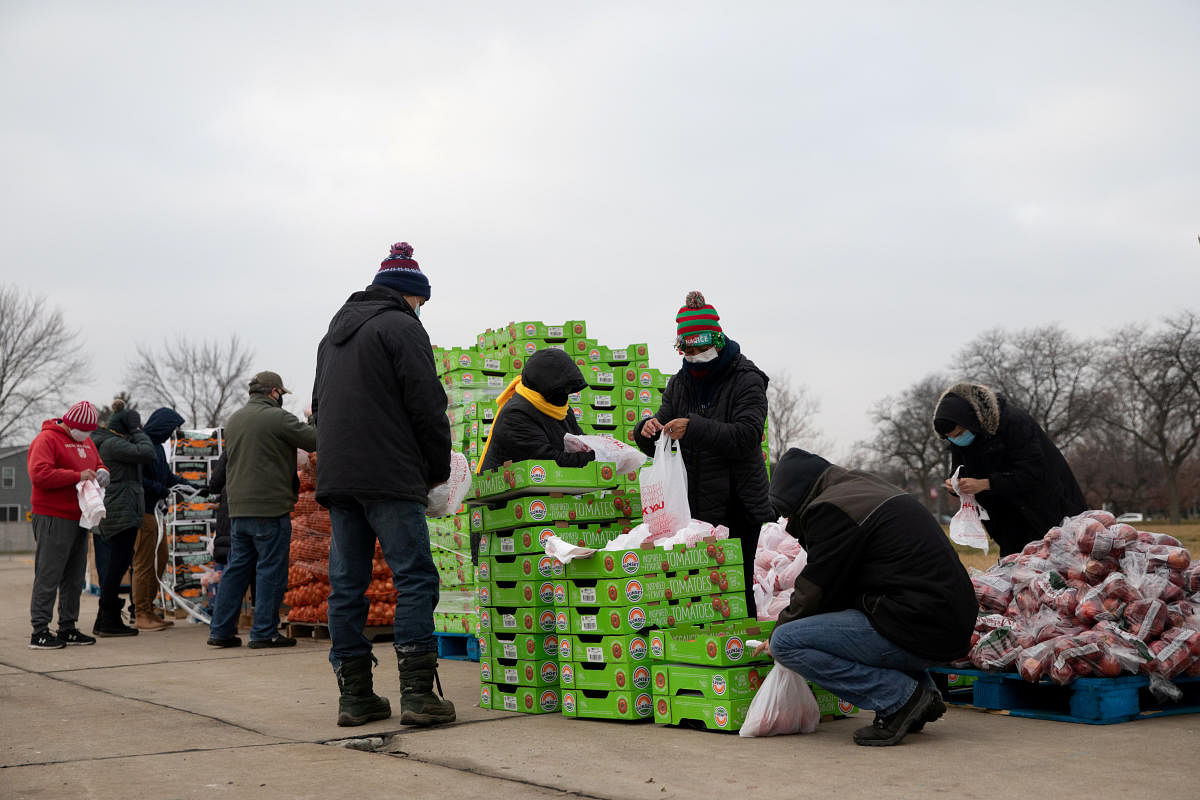 Volunteers from Forgotten Harvest food bank sort and separate different goods before a mobile pantry distribution ahead of Christmas, amid the coronavirus disease (COVID-19) pandemic in Warren, Michigan, U.S., December 21, 2020. Credit: REUTERS