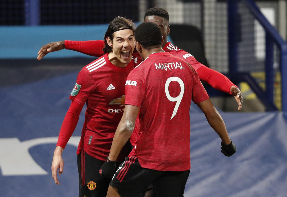 Manchester United's Edinson Cavani celebrates scoring their first goal with Anthony Martial. Credit: Reuters. 