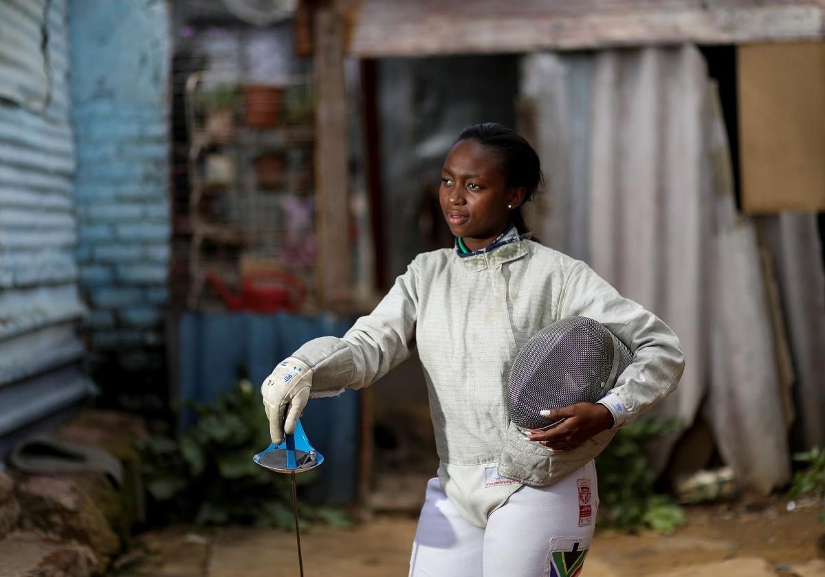 Nomvula Mbatha, 23, South Africa's number one women sabre fencer, poses for a photograph outside her home in Soweto, South Africa. Credit: Reuters.