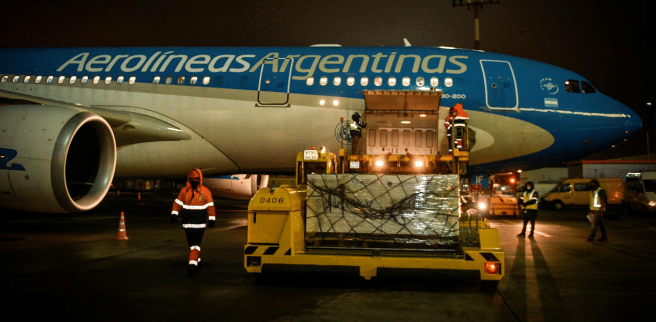 Cool boxes with doses of the Sputnik V (Gam-COVID-Vac) vaccine against Covid-19 are loaded in an Aerolineas Argentinas airplane at the Sheremetievo airport, in Moscow, Russia. Credit: Reuters